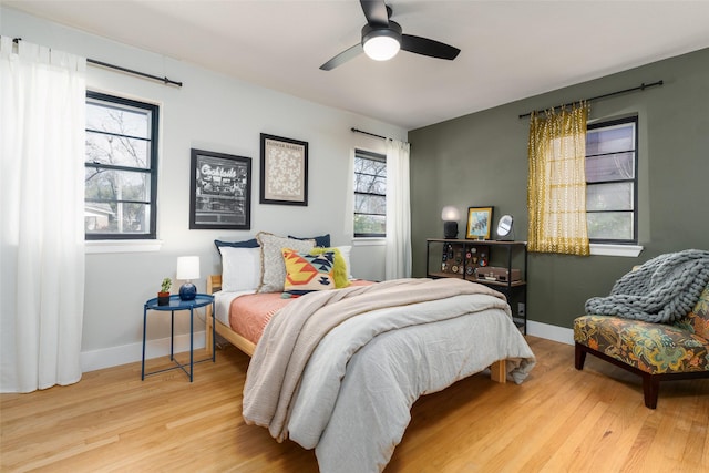 bedroom with ceiling fan and light wood-type flooring