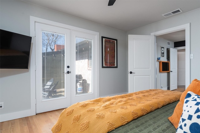 bedroom with access to exterior, wood-type flooring, french doors, and ceiling fan