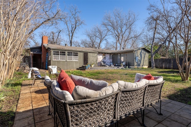 back of house featuring a patio area, outdoor lounge area, and a lawn