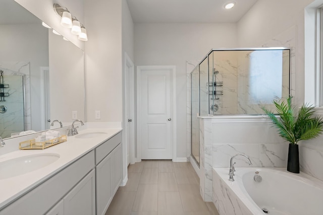 bathroom featuring a garden tub, a shower stall, and a sink