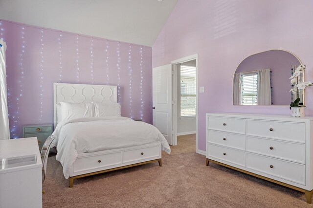 carpeted bedroom featuring wallpapered walls, baseboards, and high vaulted ceiling