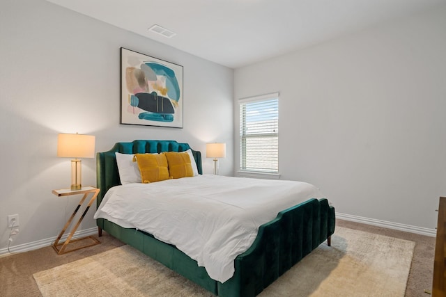 carpeted bedroom featuring visible vents and baseboards