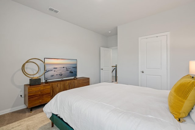 bedroom with carpet, visible vents, and baseboards