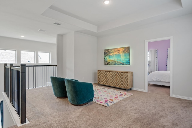 living area with carpet, recessed lighting, a raised ceiling, visible vents, and baseboards