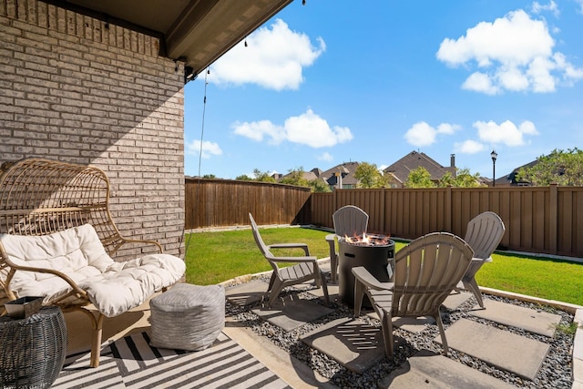 view of patio featuring an outdoor living space with a fire pit and a fenced backyard