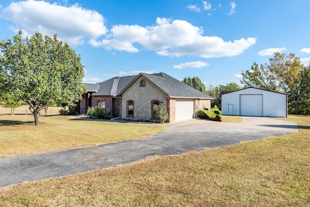 french country style house featuring a garage and a front yard