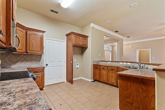 kitchen featuring sink, tasteful backsplash, light tile patterned floors, ornamental molding, and electric stove