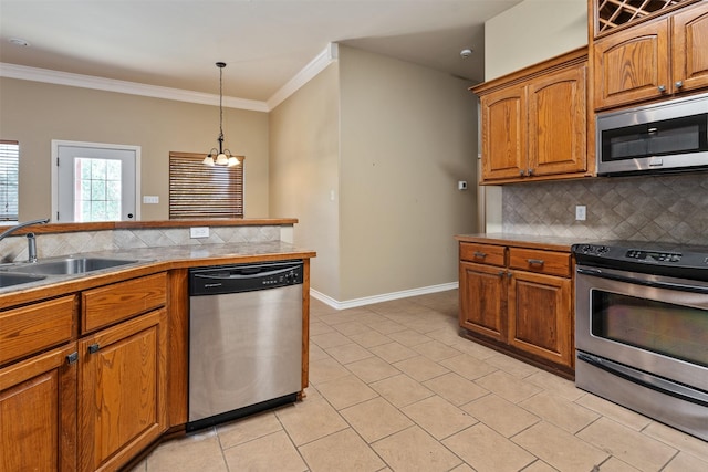 kitchen with sink, crown molding, appliances with stainless steel finishes, backsplash, and decorative light fixtures