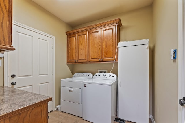 laundry area featuring cabinets and washing machine and clothes dryer