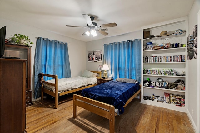 bedroom featuring wood-type flooring and ceiling fan