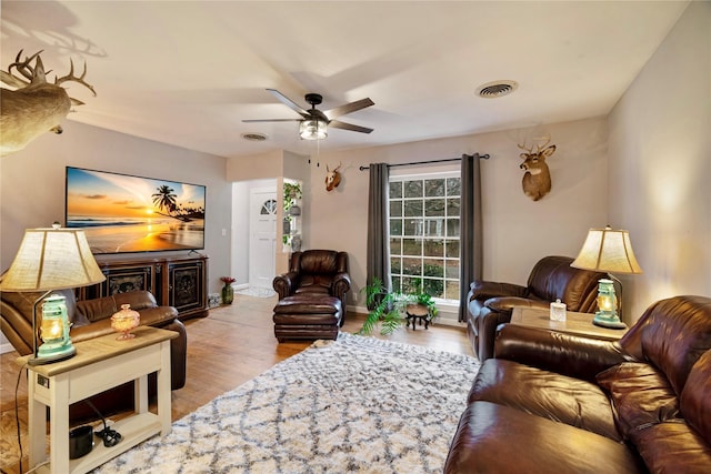 living room with ceiling fan and light wood-type flooring