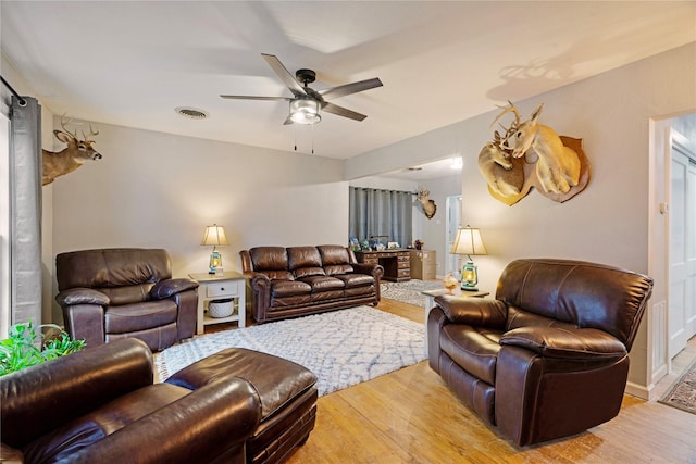 living room featuring ceiling fan and light hardwood / wood-style floors