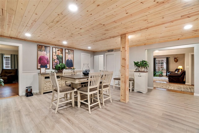 dining space with wood ceiling and light hardwood / wood-style flooring