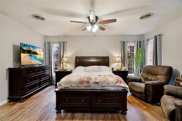 bedroom with ceiling fan and hardwood / wood-style floors