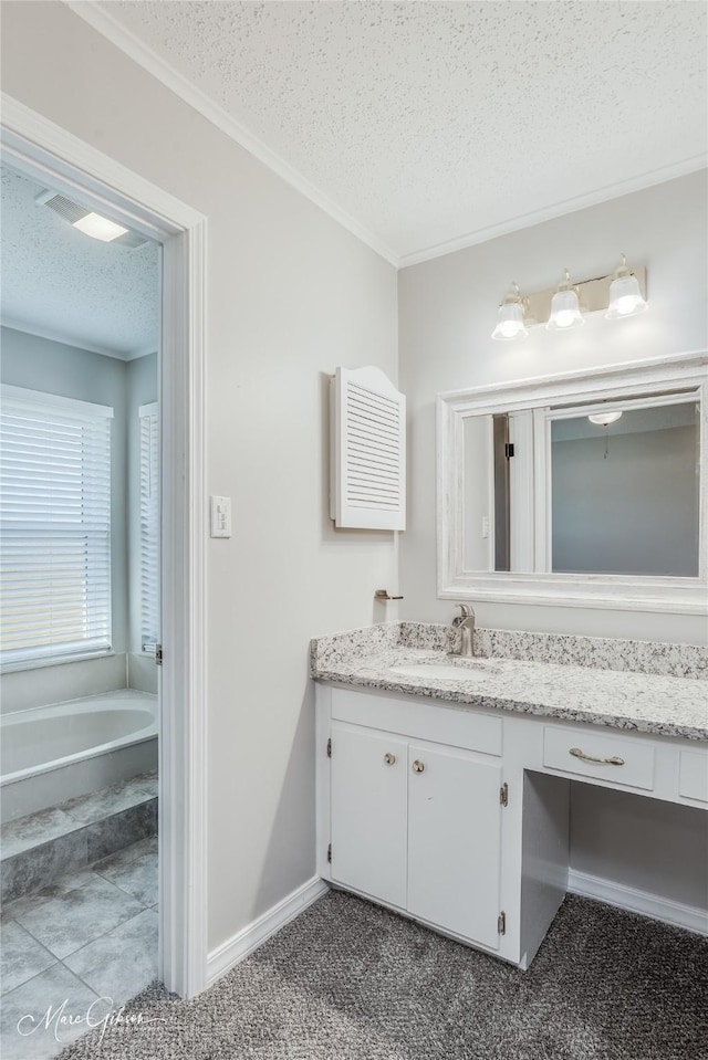 bathroom featuring crown molding, vanity, a textured ceiling, and a washtub