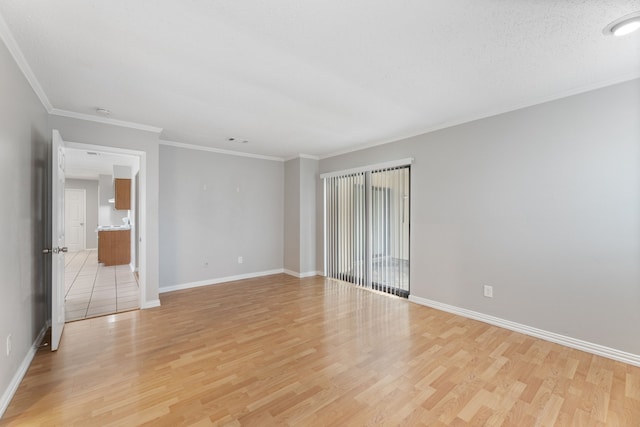 spare room with crown molding, a textured ceiling, and light wood-type flooring