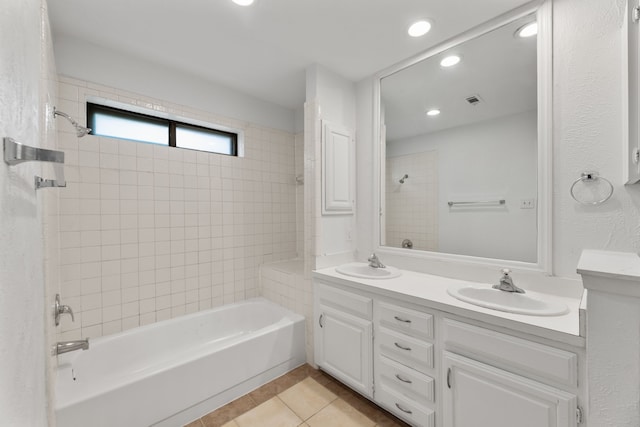 bathroom with tiled shower / bath, tile patterned floors, and vanity