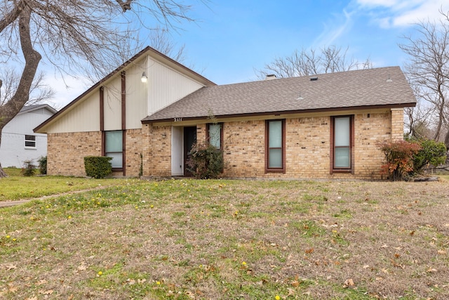 rear view of property featuring a yard