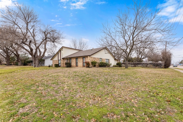 view of side of property with a lawn