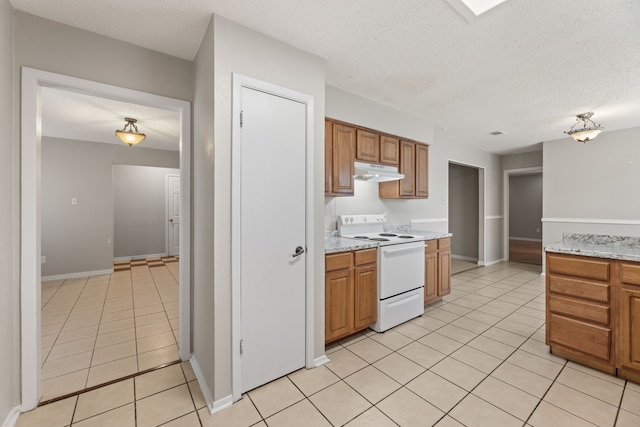 kitchen featuring white electric range, light stone countertops, a textured ceiling, and light tile patterned flooring