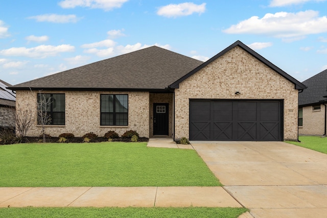 view of front of house with a garage and a front yard