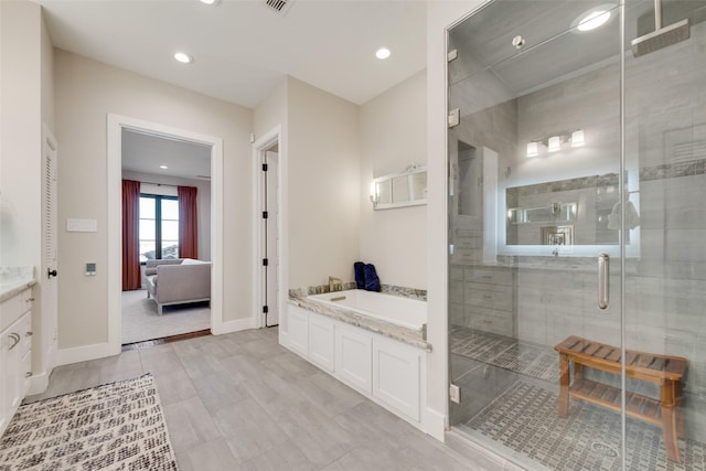 bathroom with plus walk in shower and vanity