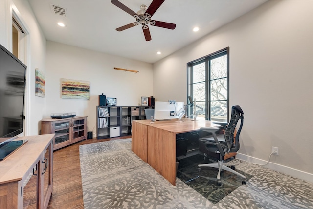 office with ceiling fan and light hardwood / wood-style flooring