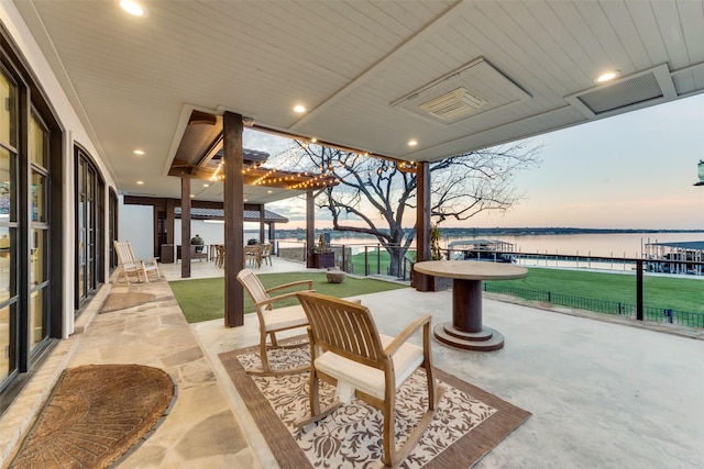 patio terrace at dusk with a water view