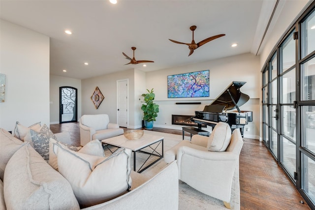 living room featuring hardwood / wood-style flooring and ceiling fan