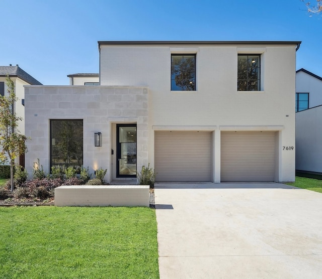 contemporary house with a garage and a front yard