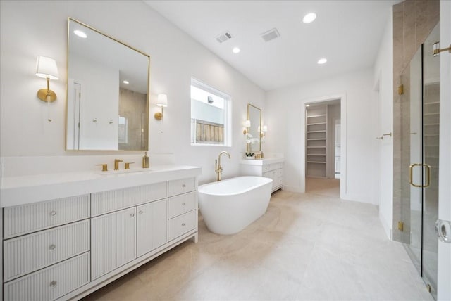 bathroom with vanity and independent shower and bath