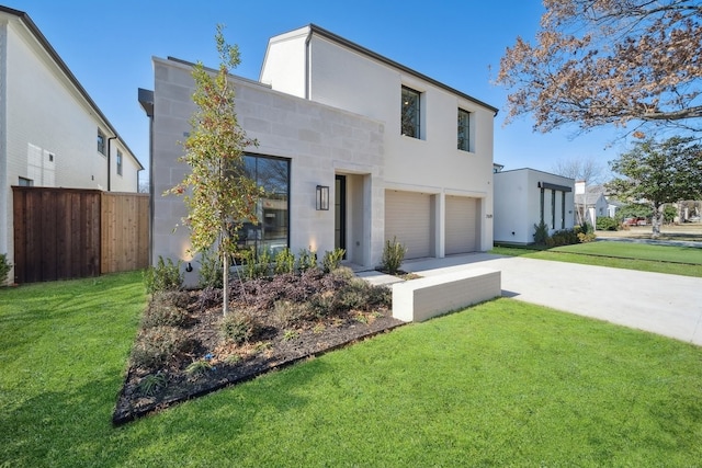 contemporary home featuring a garage and a front yard