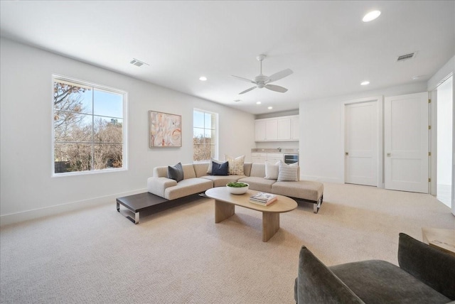 living room with light colored carpet and ceiling fan