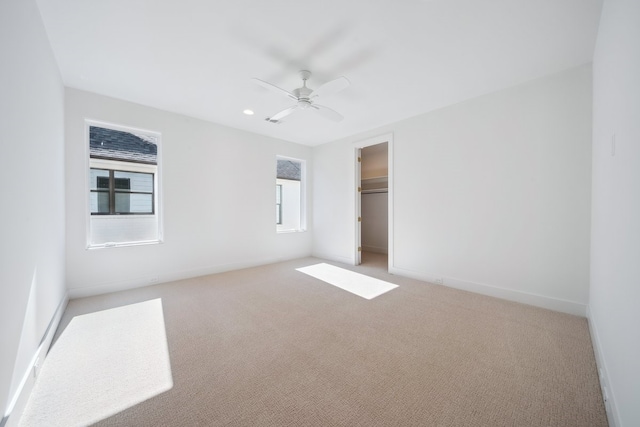 unfurnished bedroom featuring light colored carpet, a closet, and ceiling fan