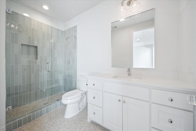 bathroom featuring tile patterned floors, vanity, toilet, and an enclosed shower