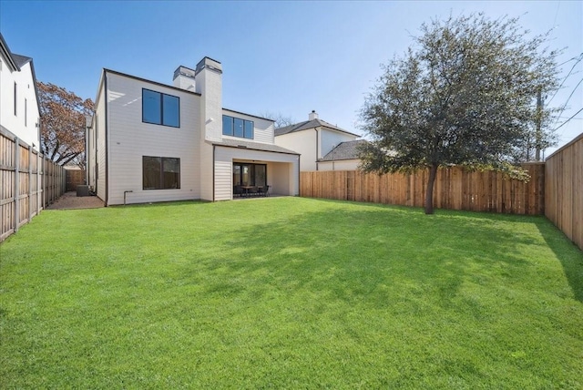 back of house featuring a lawn