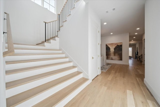 staircase with hardwood / wood-style flooring