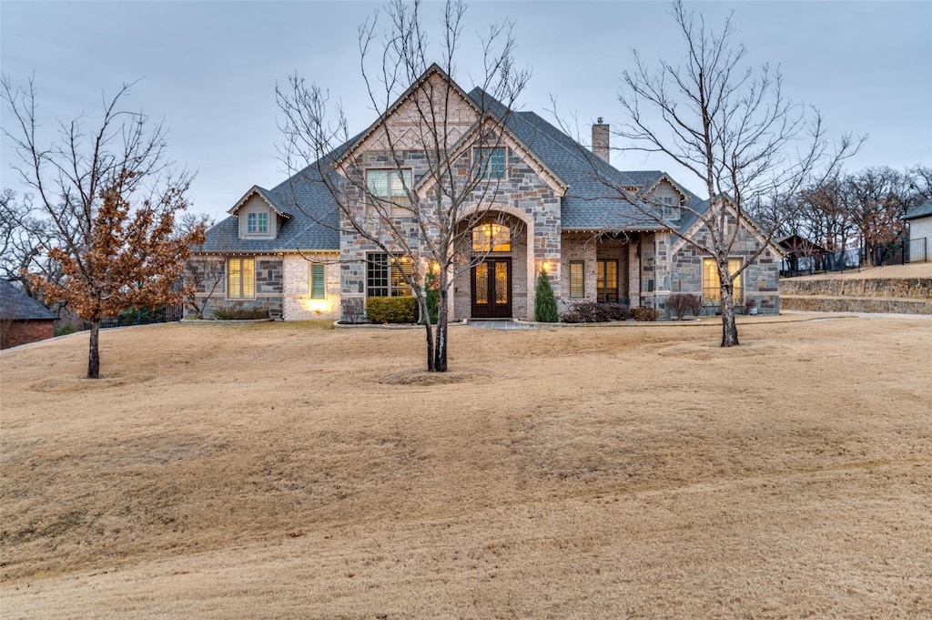 english style home with a front yard