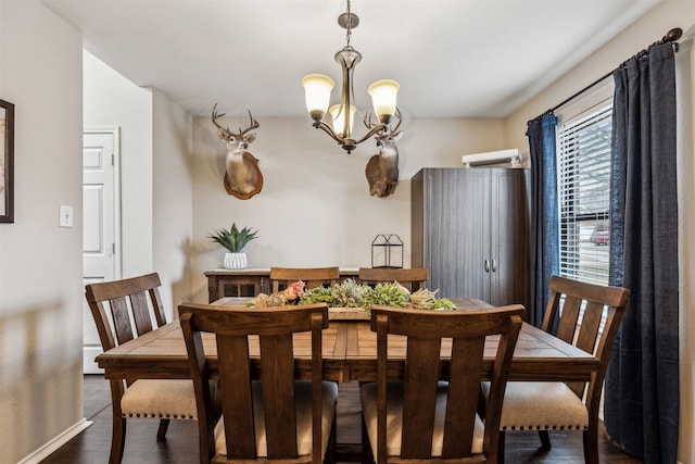 dining area with dark wood-type flooring and a notable chandelier