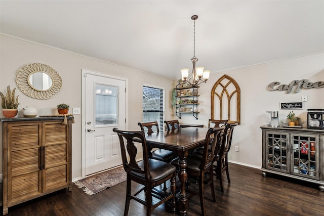 dining space with a notable chandelier and dark hardwood / wood-style floors