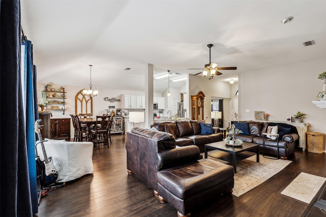 living room featuring dark hardwood / wood-style flooring, sink, ceiling fan with notable chandelier, and lofted ceiling