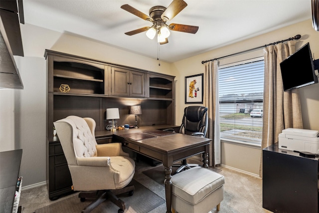 home office with light carpet and ceiling fan