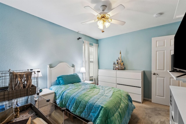 bedroom with ceiling fan and light colored carpet