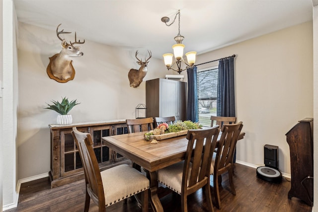 dining room with dark hardwood / wood-style floors and an inviting chandelier