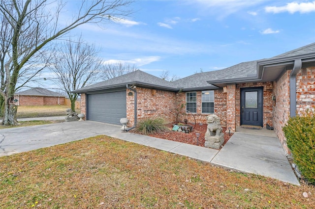 single story home with a garage and a front lawn