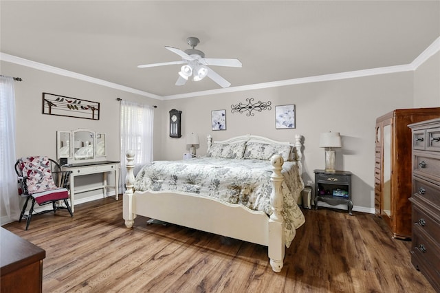 bedroom with crown molding, hardwood / wood-style floors, and ceiling fan