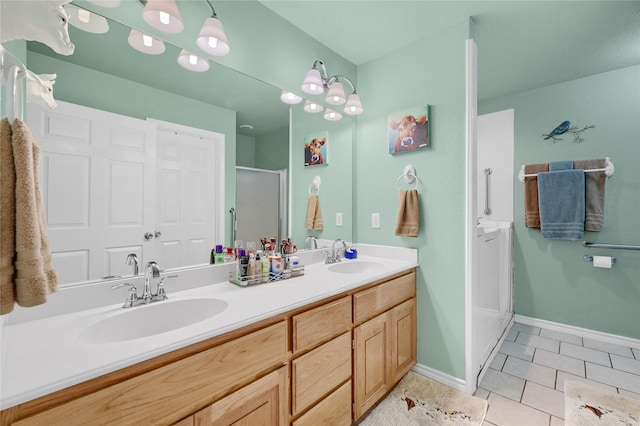 bathroom with vanity, a shower with shower door, and tile patterned floors