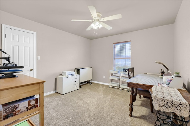 office space with light colored carpet and ceiling fan