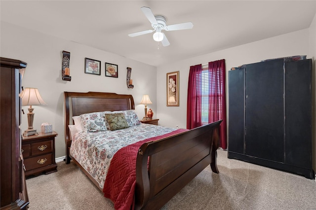 bedroom with ceiling fan and light carpet