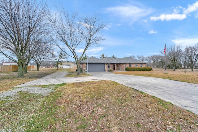 ranch-style house featuring a garage and a front lawn